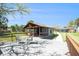 Inviting outdoor area with a covered patio, outdoor seating, and a beautifully landscaped yard at 5560 Frances Ave, New Port Richey, FL 34653
