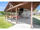 Covered pavilion with string lights, a ceiling fan, and an entertainment setup with a TV at 5560 Frances Ave, New Port Richey, FL 34653