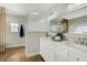Bright bathroom featuring double vanity, marble countertop, and modern glass shower at 609 Osceola Rd, Belleair, FL 33756
