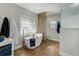 Serene bathroom featuring a freestanding tub, modern fixtures, and elegant wood-look tile at 609 Osceola Rd, Belleair, FL 33756