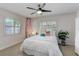 Bright bedroom featuring coastal decor, shuttered windows, and playful flamingo accents at 609 Osceola Rd, Belleair, FL 33756