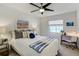 Cozy bedroom featuring a large bed with stylish throw pillows, ceiling fan and bright natural light at 609 Osceola Rd, Belleair, FL 33756