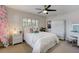 Serene bedroom with white furniture, a surfboard accent, and a cozy vanity area at 609 Osceola Rd, Belleair, FL 33756