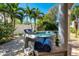 Relax in your private backyard hot tub surrounded by palm trees, perfect for outdoor relaxation at 609 Osceola Rd, Belleair, FL 33756