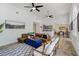 Spacious living room with a leather sofa, modern furniture, and an open layout with an adjacent dining area at 609 Osceola Rd, Belleair, FL 33756