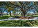 Scenic park area with a large shade tree, bench, and walking path for relaxing outdoor enjoyment at 609 Osceola Rd, Belleair, FL 33756