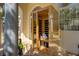 An outdoor personal sauna with a window and glass door, next to wine glasses at 609 Osceola Rd, Belleair, FL 33756