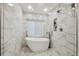 Modern bathroom featuring a standalone tub and seamless glass shower at 6109 Schooner Way, Tampa, FL 33615
