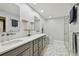 Modern bathroom with double vanity, sleek fixtures, and glass-enclosed shower at 6109 Schooner Way, Tampa, FL 33615