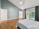 Bedroom featuring hardwood floors and views of the pool and patio at 6109 Schooner Way, Tampa, FL 33615