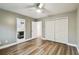 Bedroom featuring hardwood floors, a ceiling fan, and an ensuite bathroom at 6109 Schooner Way, Tampa, FL 33615