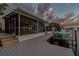 Beautiful exterior with screened-in lanai, boat dock and boat lift overlooking the serene canal, perfect for outdoor enjoyment at 6109 Schooner Way, Tampa, FL 33615
