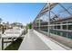 Waterfront property features a screened-in lanai and private dock, offering seamless indoor-outdoor living by the canal at 6109 Schooner Way, Tampa, FL 33615
