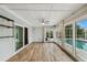 Bright Florida room with tile floor and lots of light overlooking outdoor swimming pool at 6109 Schooner Way, Tampa, FL 33615
