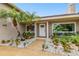 Inviting front entrance featuring meticulous landscaping with white rocks and tropical plants around the pathway at 6109 Schooner Way, Tampa, FL 33615