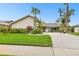 Attractive single-story home with tropical landscaping, white rock accents, and an inviting front lawn at 6109 Schooner Way, Tampa, FL 33615