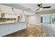 Spacious kitchen flowing into living space, featuring granite counters and access to Florida room at 6109 Schooner Way, Tampa, FL 33615
