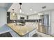 Updated kitchen with granite countertops, stainless steel appliances, stylish tile backsplash, and white cabinets at 6109 Schooner Way, Tampa, FL 33615