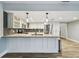 Kitchen with granite countertops, white cabinetry, stainless appliances, open to adjacent living spaces at 6109 Schooner Way, Tampa, FL 33615