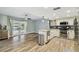 Open kitchen featuring white cabinets, granite countertops, stainless steel appliances, and a waterfront view at 6109 Schooner Way, Tampa, FL 33615