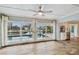 Open-concept living area with wood-look tile floors and views of the pool and water at 6109 Schooner Way, Tampa, FL 33615