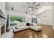 Bright living room boasts wood floors, a large ceiling fan, and a cozy fireplace with stone surround at 6109 Schooner Way, Tampa, FL 33615