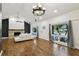 Open living room with hardwood floors, a ceiling fan, fireplace, and a bright atmosphere with a large window at 6109 Schooner Way, Tampa, FL 33615