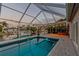 Inviting screened pool with lights and canal view offers a relaxing outdoor space for waterfront living and entertaining at 6109 Schooner Way, Tampa, FL 33615