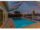 Evening illuminates private pool area with tranquil waterway views, perfect for relaxation at 6109 Schooner Way, Tampa, FL 33615
