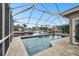 Screened pool and deck area offer waterfront relaxation and boat access for entertainment at 6109 Schooner Way, Tampa, FL 33615