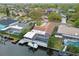 Waterfront home featuring a screened pool, dock, and boat lift on a canal at 6109 Schooner Way, Tampa, FL 33615