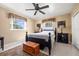 Comfortable bedroom with neutral walls, hardwood bed frame and decor, and natural light from windows at 6950 12Th N Ave, St Petersburg, FL 33710