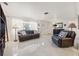 Bright living room with polished terrazzo floors and comfortable leather furniture at 6950 12Th N Ave, St Petersburg, FL 33710