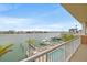 Balcony view of waterfront property with docks, boats, and a swimming pool at 706 Bayway Blvd # 301, Clearwater Beach, FL 33767