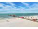 Picturesque beach view showcasing a long pier extending into the ocean at 706 Bayway Blvd # 301, Clearwater Beach, FL 33767