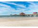 Scenic beach view featuring a long pier stretching into the serene ocean waters at 706 Bayway Blvd # 301, Clearwater Beach, FL 33767