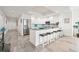 Kitchen area featuring white cabinetry, stainless steel appliances, and seating at 706 Bayway Blvd # 301, Clearwater Beach, FL 33767