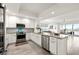 Bright, open kitchen featuring granite countertops, stainless steel appliances, and modern white cabinetry at 706 Bayway Blvd # 301, Clearwater Beach, FL 33767