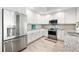 Kitchen with modern stainless-steel appliances and white cabinets at 706 Bayway Blvd # 301, Clearwater Beach, FL 33767