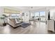 Bright living room featuring tiled floors, modern furnishings, and water views at 706 Bayway Blvd # 301, Clearwater Beach, FL 33767