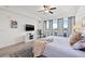 Bright main bedroom with water views, large windows, ceiling fan, and access to an outdoor balcony at 706 Bayway Blvd # 301, Clearwater Beach, FL 33767