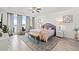Bright main bedroom with water views, large windows, ceiling fan, and access to an outdoor balcony at 706 Bayway Blvd # 301, Clearwater Beach, FL 33767