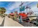 Lively marina scene with boats, shops, and attractions, perfect for tourists at 706 Bayway Blvd # 301, Clearwater Beach, FL 33767