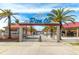 Charming walkway entrance to Pier 60 with palm trees and beach access at 706 Bayway Blvd # 301, Clearwater Beach, FL 33767