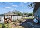 Fenced backyard with a woodpile, offering a private and functional outdoor space at 725 Philippe Pkwy, Safety Harbor, FL 34695