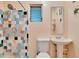 Cozy bathroom features colorful tile in shower and bright pedestal sink at 725 Philippe Pkwy, Safety Harbor, FL 34695