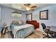 Bright bedroom with blue walls, wood floors, ceiling fan, desk area, and decor at 725 Philippe Pkwy, Safety Harbor, FL 34695
