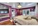 Comfortable bedroom boasts hardwood floors, doors leading to patio, and a decorative chandelier at 725 Philippe Pkwy, Safety Harbor, FL 34695