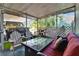 Enclosed patio with comfortable seating, offering a relaxed atmosphere and connection to the outdoors at 725 Philippe Pkwy, Safety Harbor, FL 34695
