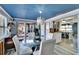 Bright dining area featuring modern lighting, glass table, and a view of the outdoor patio at 725 Philippe Pkwy, Safety Harbor, FL 34695